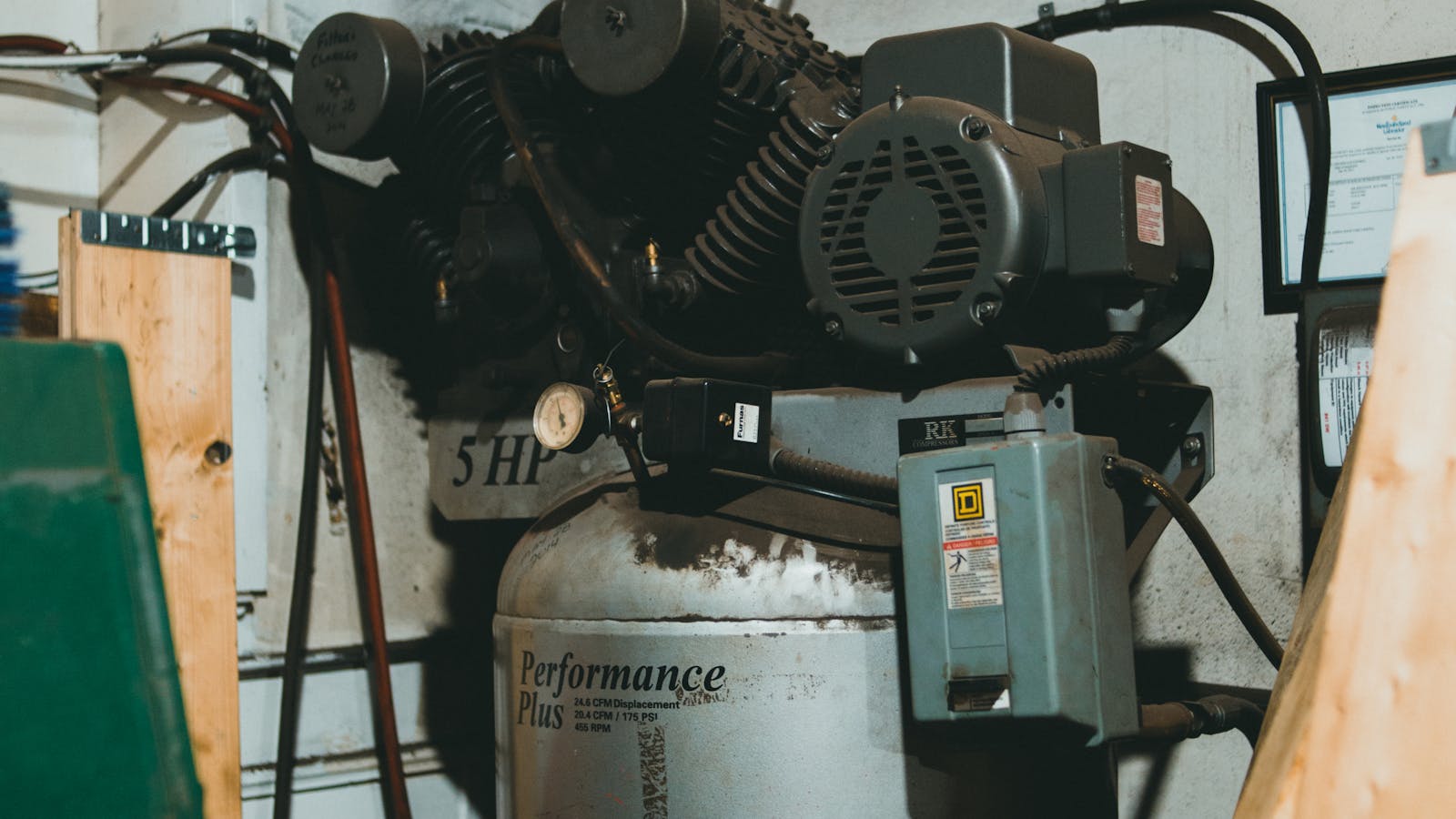 Industrial air compressor with pressure gauge and pipework