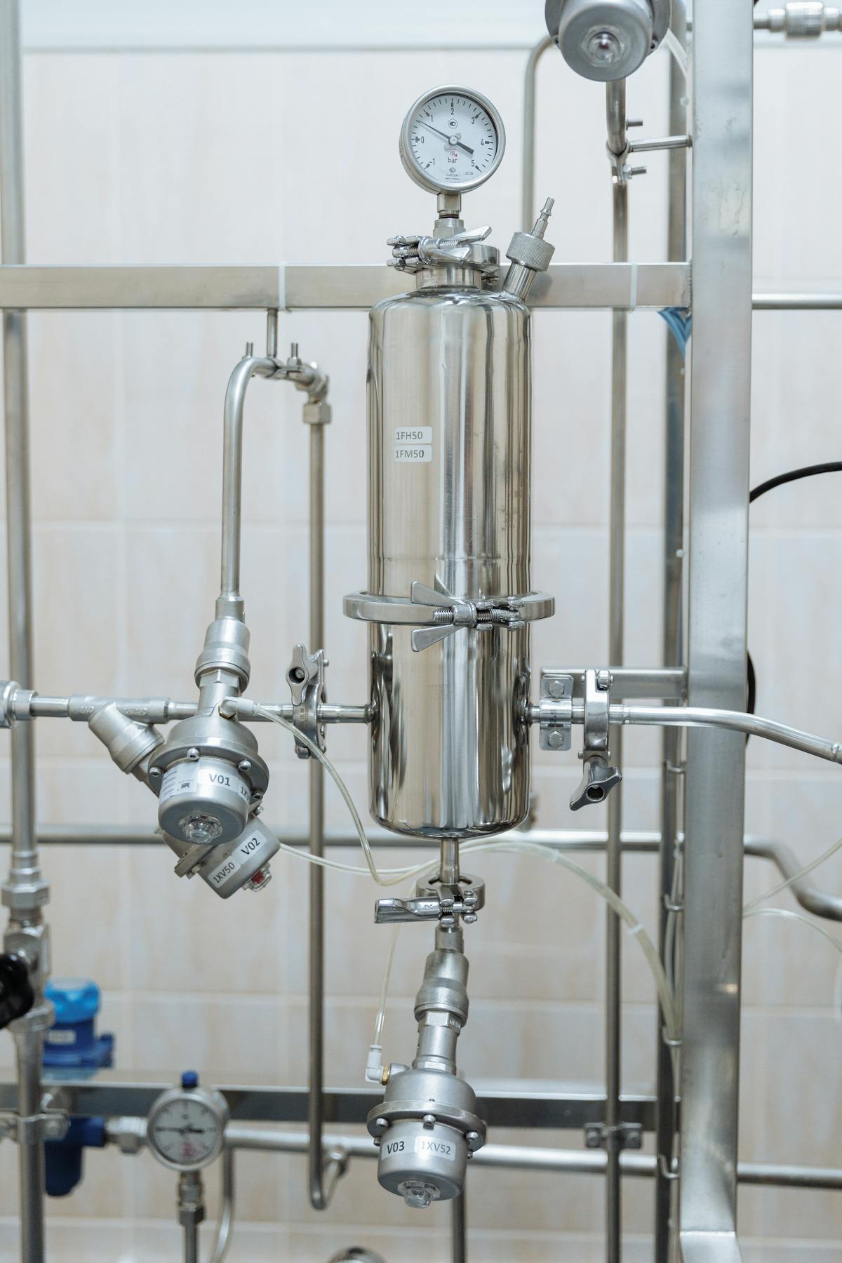 Stainless steel compressed air pipework with pressure gauges and valves