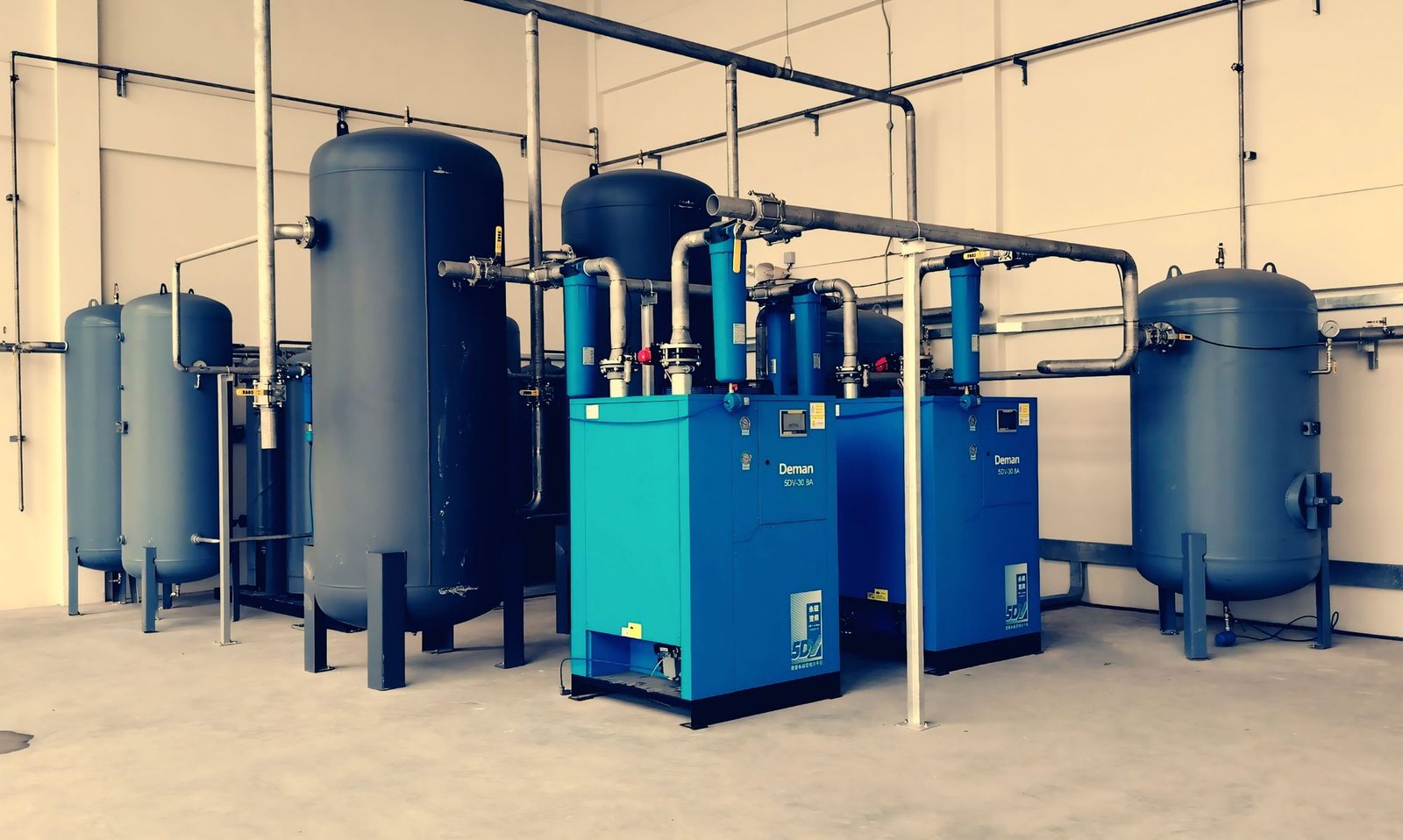 Industrial air compressor and pipework on a UK factory site.