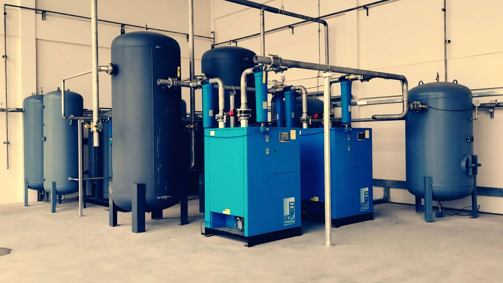 A variable speed drive rotary screw compressor running in an industrial plant room
